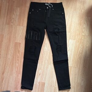 AMIRI Black Skinny Jeans with Subtle Distressed Detail